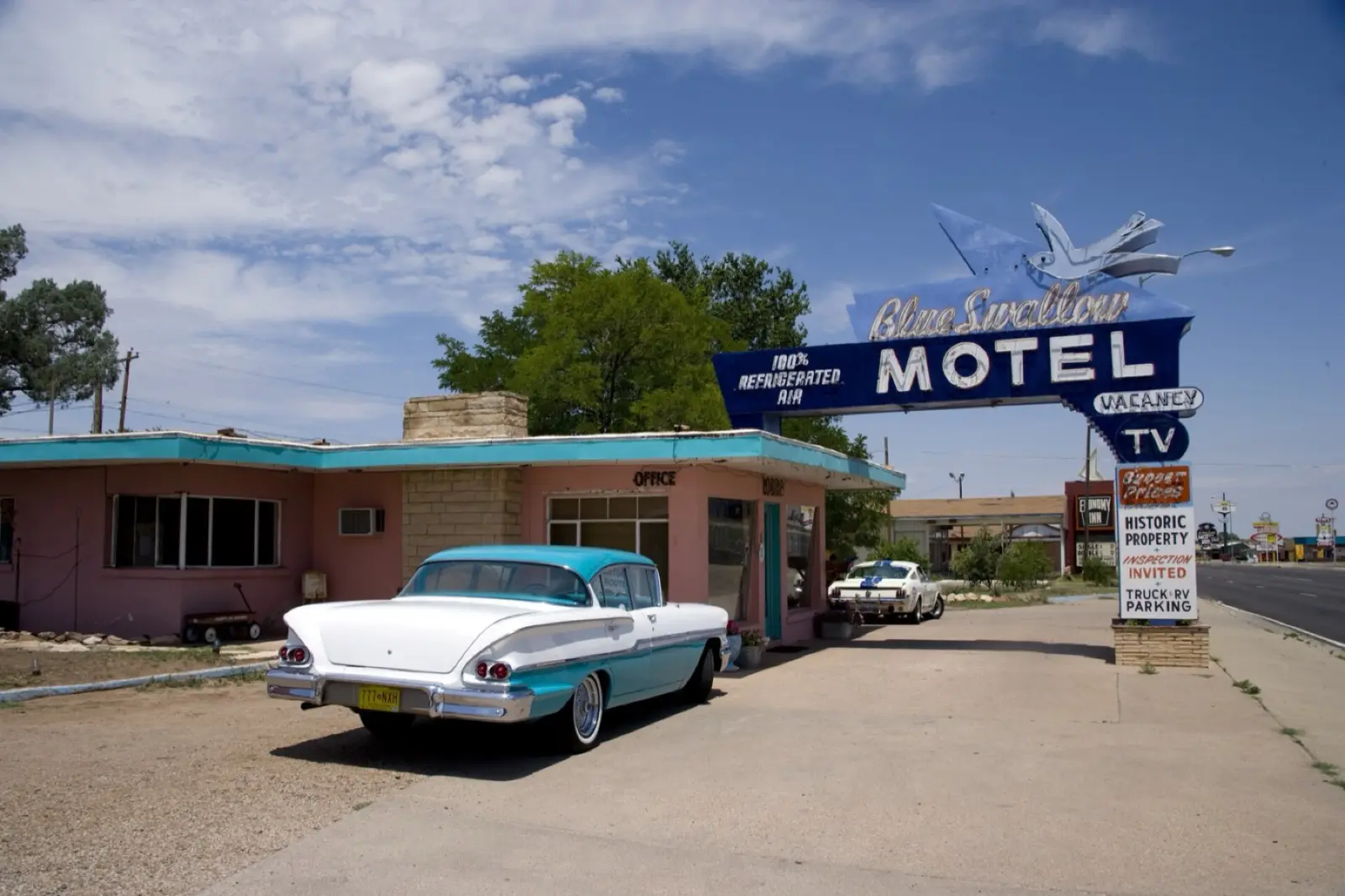 Blue Swallow Motel neon sign and a 1950s car in Tucumcari, New Mexico